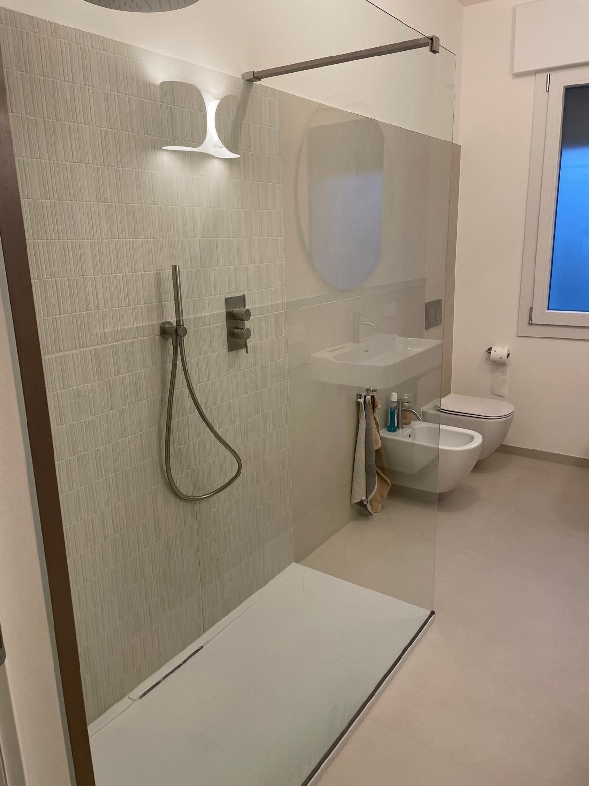 Bagno ristrutturato chiavi in mano con ampia doccia walk-in in vetro e sanitari sospesi a Padova