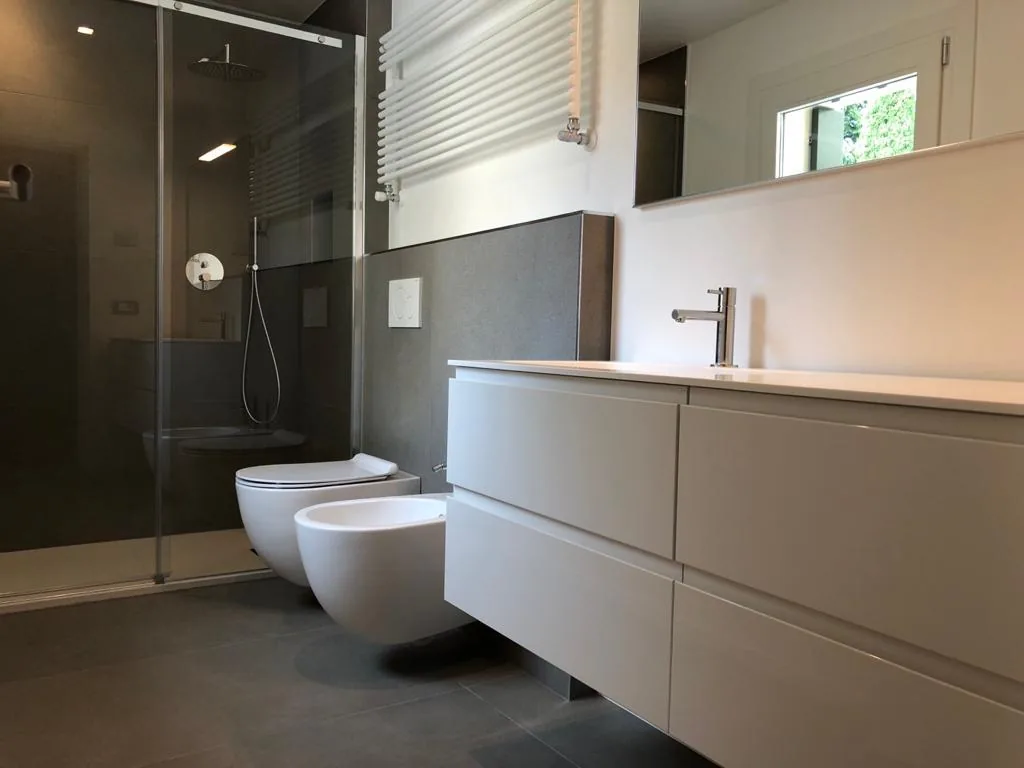 Bagno ristrutturato chiavi in mano Brugnolo Termoidraulica Padova con doccia walk-in in vetro e mobile sospeso bianco